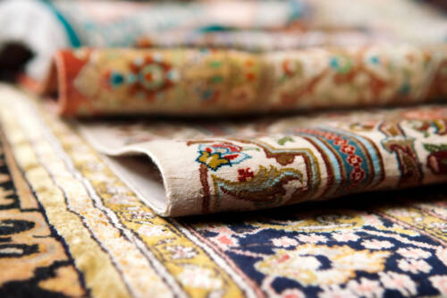 Beautifully patterned Persian rugs stacked